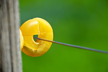 selective focus photography of round yellow bead on string thumbnail