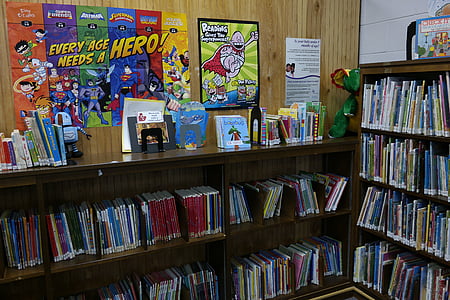 comic books in brown wooden bookshelves thumbnail