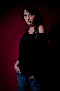 woman wearing black off-shoulder long-sleeved shirt with red background photography thumbnail