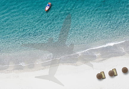 silhouette of airplane on beachside thumbnail