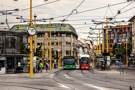 two green and red trams on paved road thumbnail