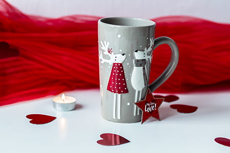 gray ceramic mug beside white tealight candle thumbnail