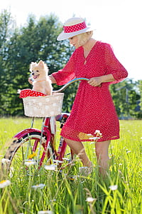 woman standing beside bicycle on grass thumbnail