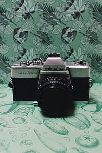 Black and Gray Film Camera on Green Floral Textile thumbnail