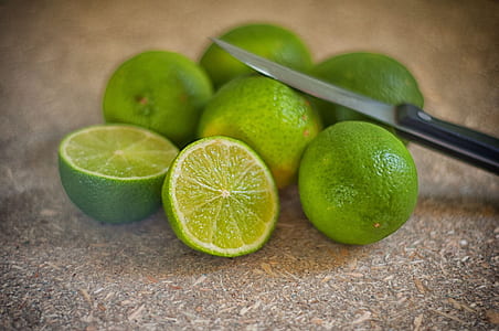 selective focus photography of slice lime fruit with black handled knife thumbnail