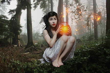 woman holding glowing jar sitting in forest thumbnail