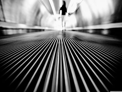 Greyscale Photography of Man Walking on Tunnel thumbnail