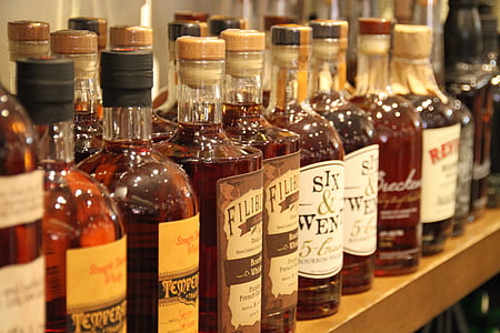 assorted-brand wine bottles on wooden surface thumbnail