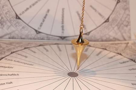 gold-colored hanging accessory near chart papers thumbnail