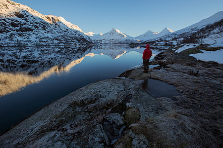 man standing in front of body of water thumbnail
