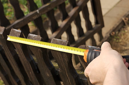 person measuring fence thumbnail