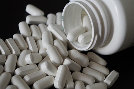 white medication tablets with container thumbnail
