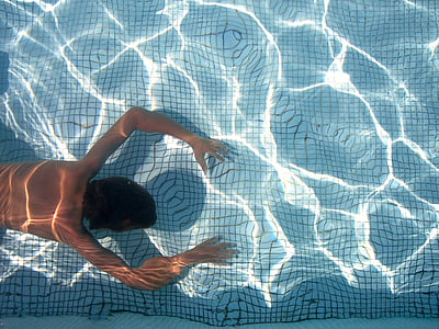 person swimming under the water thumbnail