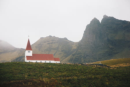red and white church near mountain thumbnail