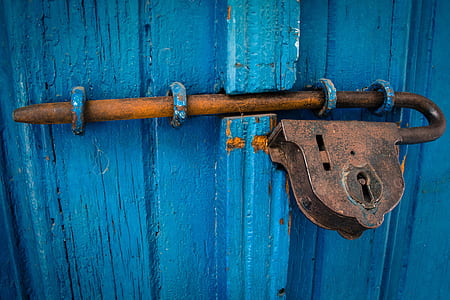 brown steel padlock on blue wooden door thumbnail
