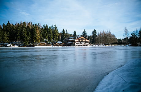 brown wooden house across body of water thumbnail