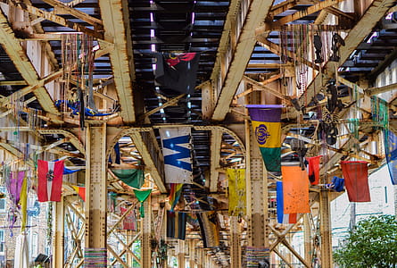 Assorted Flags Under Steel Train Rail thumbnail
