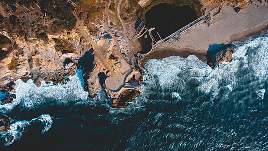 aerial photography of ocean waves hitting shore thumbnail