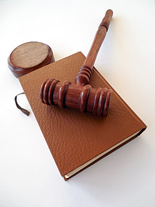 brown wooden mallet on top of brown book thumbnail