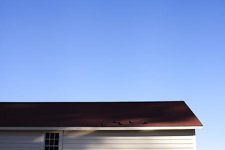 brown house roof under blue sky at daytime thumbnail