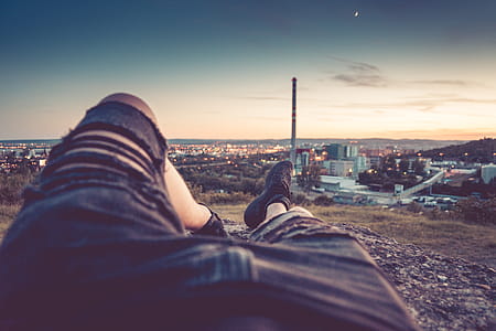 Young Man Chilling and Enjoying Evening Cityscape View thumbnail