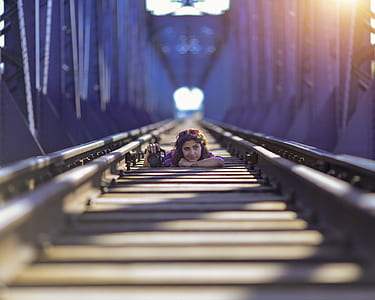 low-angle photography of woman between rail thumbnail
