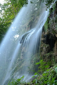 waterfalls with green plant on the rock mountain thumbnail