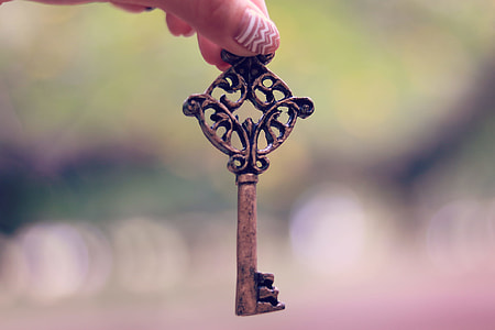 person holding brown steel skeleton key thumbnail