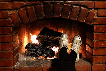 person's foot in brick fireplace thumbnail
