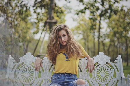 woman sitting on white metal bench thumbnail
