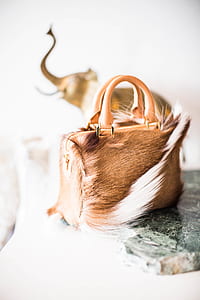 brown fur handbag on grey marble-top thumbnail