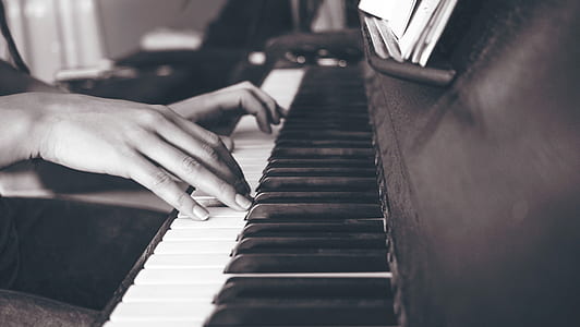 grayscale photo of woman playing guitar thumbnail