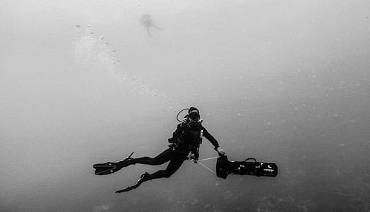 man holding device underwater photo thumbnail