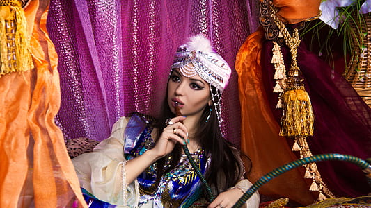woman in blue and white dress using hookah thumbnail