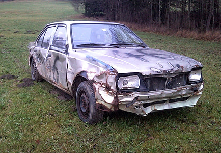 wrecked gray sedan on gras thumbnail