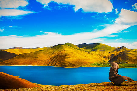 aerial view photography of body of water with mountain background thumbnail