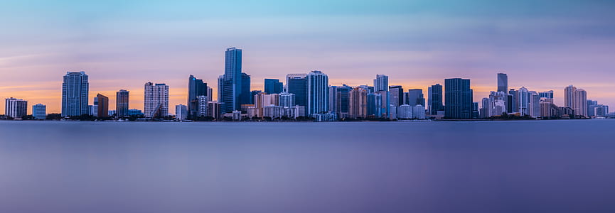 body of water and city during sunset thumbnail