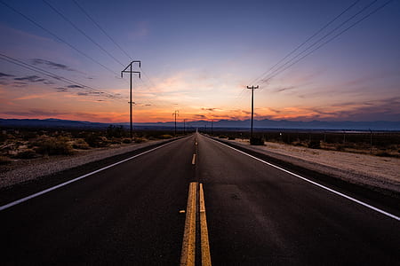 gray concrete road with utility post aside at sunset thumbnail