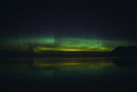 photo of body of water under sky at nighttime thumbnail