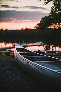 selective focus photograph of white canoe on gray surface thumbnail