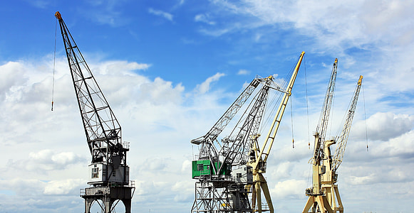 brown industrial machines under white clouds thumbnail