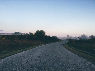 gray Asphalt road between green grass during dusk thumbnail