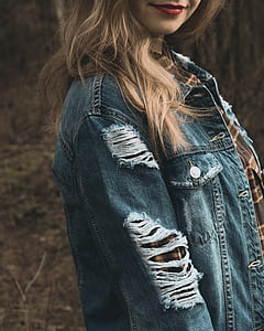 smiling woman with red lipstick wearing distressed blue denim western shirt thumbnail