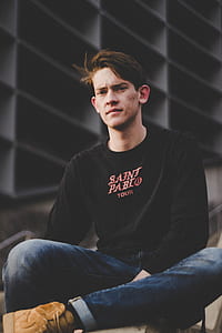 man sitting on surface thumbnail