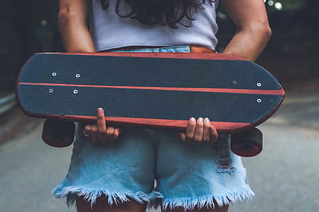 person holding black cruiser board thumbnail