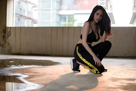 black haired woman in black and yellow sweat pants thumbnail