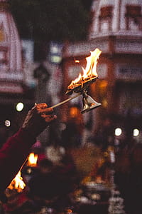 Person Holding Lamp With Flame thumbnail