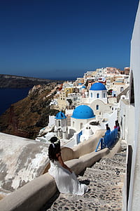 woman in white gown sitting on staircase thumbnail