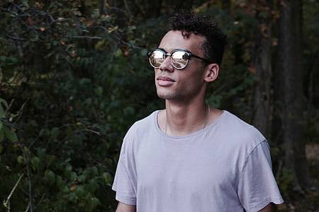 man wearing sunglasses beside tree thumbnail