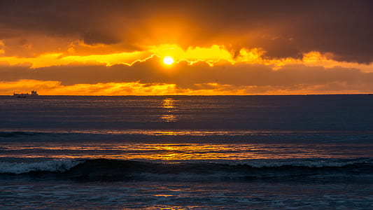 waves rushed to shore at sunsset thumbnail